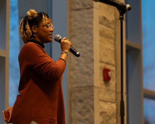 Woman leading poetry slam.